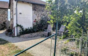 a couple of chairs sitting in a garden at La parenthèse bucolique in Cheissoux