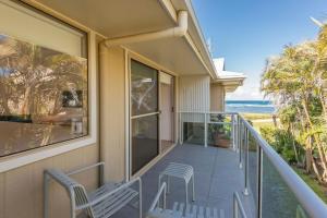 a balcony with two chairs and a view of the ocean at Bombora in Lennox Head