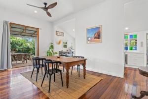 a dining room with a table and chairs at Hinterland Views in Lennox Head