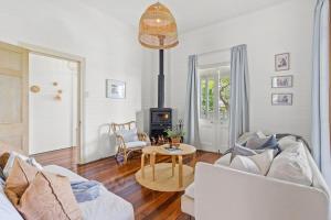 a living room with a couch and a table at Hinterland Views in Lennox Head