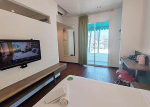 a hotel room with a flat screen tv on the wall at Yan Hotel in George Town