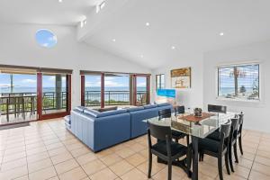 a living room with a blue couch and a table at Oceanic 3 in East Ballina