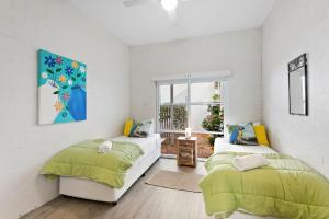 a bedroom with two beds and a window at Quarterdeck 18 in Lennox Head +5 photos