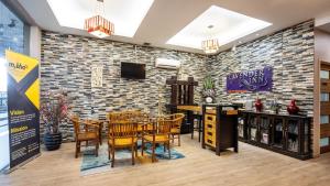 a restaurant with a brick wall and a table and chairs at Lavender Inn Permas Jaya in Johor Bahru