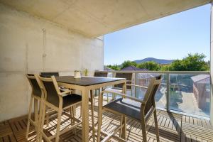 a table and chairs on a balcony with a view at Spacious Studio in a Prime Braddon Location - Hosted by Canstay in Braddon