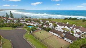 an aerial view of a house with a tennis court at Quarterdeck 23 in Lennox Head