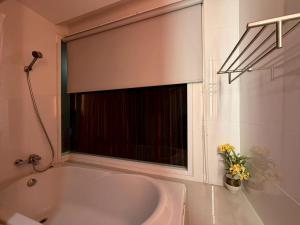 a white bath tub with a window in a bathroom at Korapura Resort in Nakhon Ratchasima +33 photos