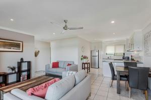 a living room with a couch and a table at Surf Sea and Sand in East Ballina