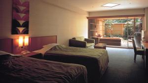 Postel nebo postele na pokoji v ubytování Akazawa Onsen Hotel