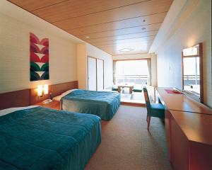 Postel nebo postele na pokoji v ubytování Akazawa Onsen Hotel
