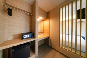 a small bathroom with a tv and a bed at Samed Amoris Resort & Pool Villas in Ko Samed