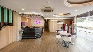 a restaurant with a counter and stools in a room at Lavender Inn Nusa Bestari in Johor Bahru