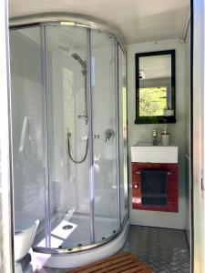 a bathroom with a shower and a toilet and a sink at Glam Camping Queenstown in Queenstown