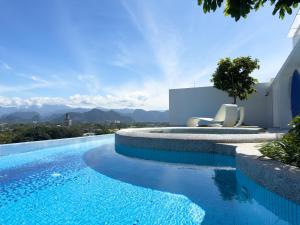 a swimming pool with a view of the mountains at Stallionz by KLIQ in Ipoh