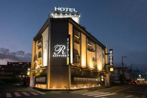 a hotel building with a sign on top of it at ホテルラフィネ in Toyonaka