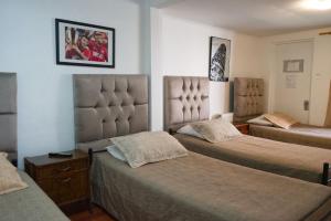 a hotel room with two beds and aintendent at Hostal Estadio Nacional in Santiago +42 photos