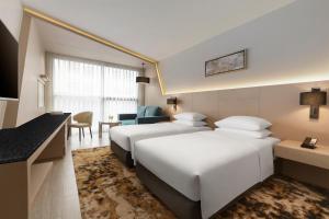 a hotel room with two beds and a desk at Hyatt Place Bangkok Sukhumvit 1 in Bangkok +49 photos