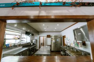 a large kitchen with stainless steel appliances at sneaky peaks in Hakuba