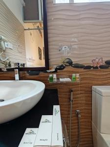 a bathroom with a white sink and a toilet at Paragon Villa Madiha in Matara