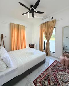 a bedroom with a bed and a ceiling fan at Teratak Zara in Kota Tinggi +59 photos
