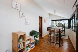 a room with a table and chairs in a house at Ironbark Oasis - Serene Poolside Haven by Mudgee CBD in Mudgee