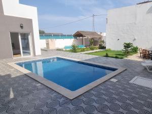 a swimming pool in the backyard of a house at Dar fadloun in Midoun