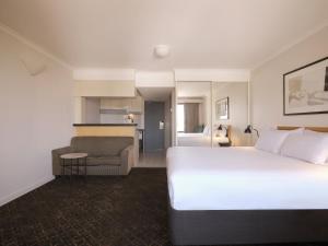 a hotel room with a large bed and a chair at Rendezvous Hotel Sydney The Rocks in Sydney +35 photos
