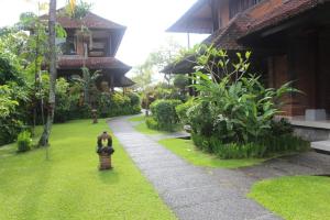 a garden with a fire hydrant next to a building at Sri Aksata Ubud Resort in Ubud +104 photos