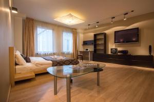 a living room with a couch and a table at Old Riga Galleria Apartment in Riga