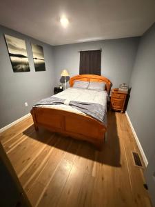 a bedroom with a bed and a wooden floor at The Eagles Nest in London