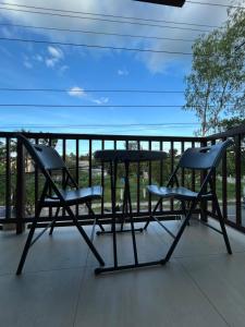 two chairs and a table on a balcony at Yalyn's Hometel Kabankalan in Kabankalan