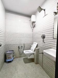 a bathroom with a toilet and a sink at Hotel Karnavati Motera Ahmedabad in Ahmedabad +16 photos