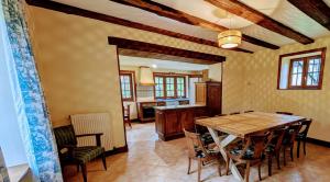 a kitchen and dining room with a table and chairs at Maison des bois in Château-Chervix
