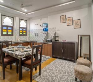 a dining room with a table and chairs in a kitchen at Footprint Hostel Udaipur in Udaipur