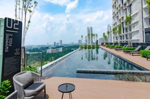 a swimming pool on the side of a building at 9am-5pm, SAME DAY CHECK IN AND CHECK OUT, Work from Home, Comfy & Quiet Tamarind Suites-Cyberjaya by Flexihome-MY, in Cyberjaya