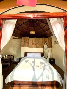 a bedroom with a large bed with a canopy at Charming - attractive - pristine nature - peaceful in Vũ Lâm +30 photos