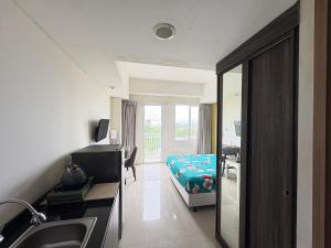 a hospital room with a bed and a mirror at Studio Bogor Icon Apt wifi&pool in Kedunghalang