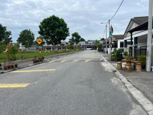 an empty street in a small town with houses at LAMAN SUZY Seri Iskandar in Seri Iskandar