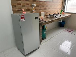 a kitchen with a refrigerator and a counter at LAMAN SUZY Seri Iskandar in Seri Iskandar