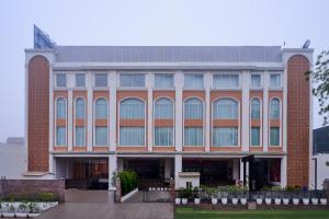 a large brick building with a lot of windows at Skywings Sarovar Portico Mathura in Mathura