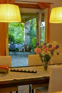 a dining room table with a vase of flowers and lights at Villa With Private Pool In Umbria in Umbertide