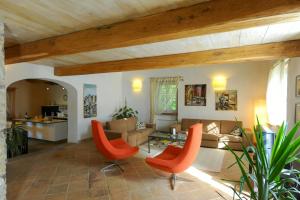a living room with orange chairs and a couch at Villa With Private Pool In Umbria in Umbertide +24 photos