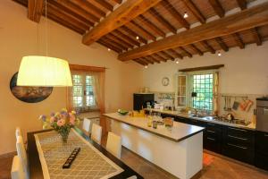 a large kitchen with a table and a counter top at Villa With Private Pool In Umbria in Umbertide
