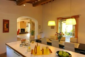 a kitchen and living room with a table and chairs at Villa With Private Pool In Umbria in Umbertide