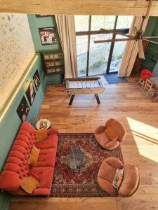 an overhead view of a living room with a red couch at House And Playful Barn in Verrières