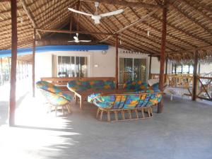 a living room with couches and chairs in a pavilion at Villa Ny Onja in Mahajanga