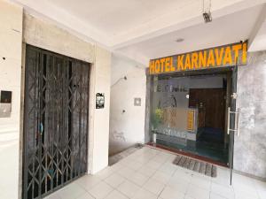a front door of a store with a sign on it at Hotel Karnavati Motera Ahmedabad in Ahmedabad