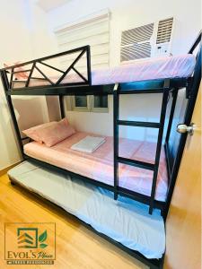 a bunk bed in a room with a bunk bed on the floor at Trees Residences Staycation 2 Bedroom in Manila