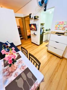 a room with a table with flowers on it at Trees Residences Staycation 2 Bedroom in Manila