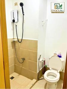 a bathroom with a shower with a toilet in it at Trees Residences Staycation 2 Bedroom in Manila +10 photos
